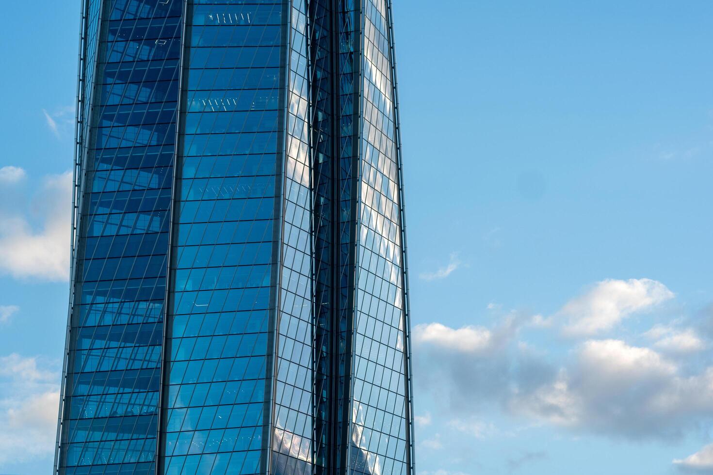 modern architecture, glass facade element of skyscraper against evening sky photo