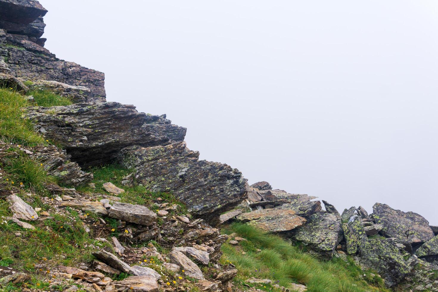 mountain landscape, rocks on a mountainside in thick fog photo