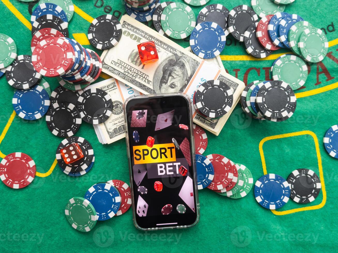 online casino smartphone with poker chips device over green table photo