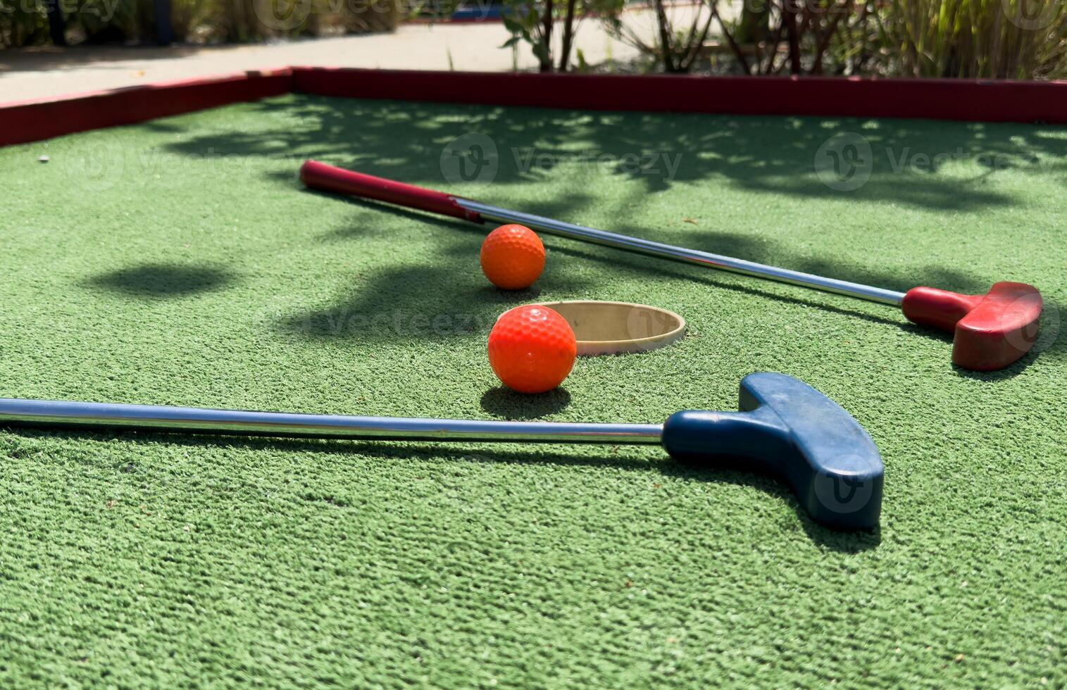Closeup of player play mini golf with ball photo