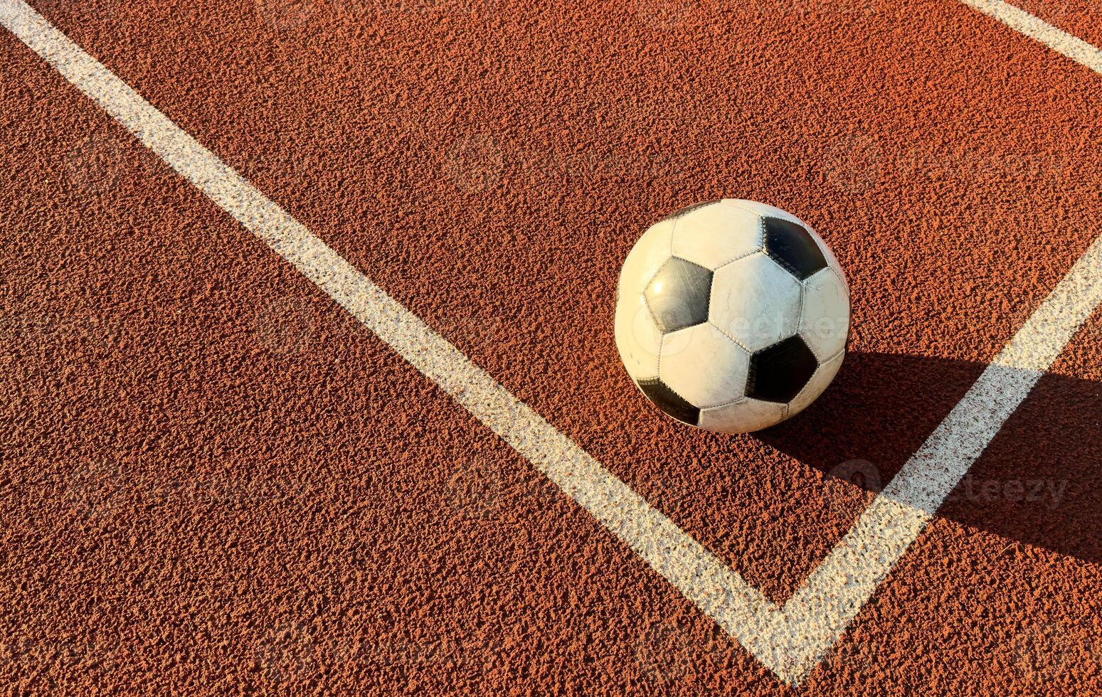 Traditional soccer ball on soccer playground photo