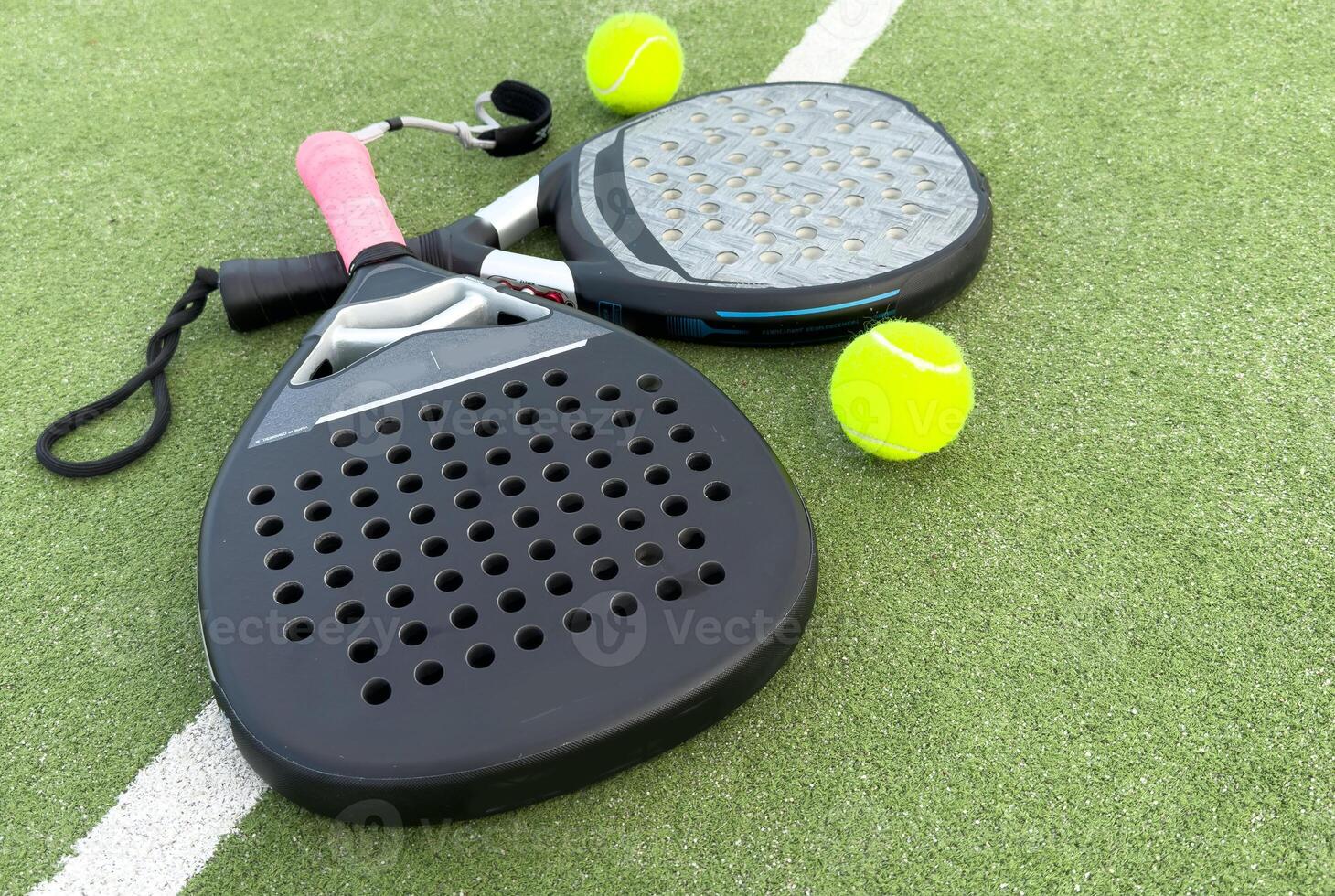 paddle tennis racket and balls on court photo