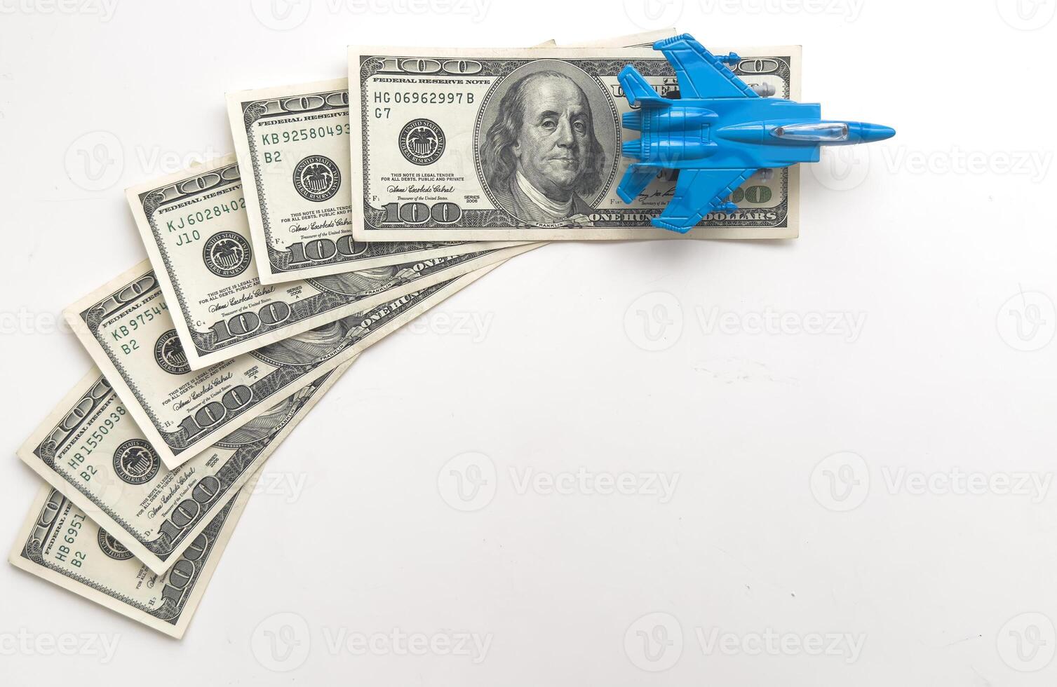 Background of one hundred dollar bills with model fighter airplane photo