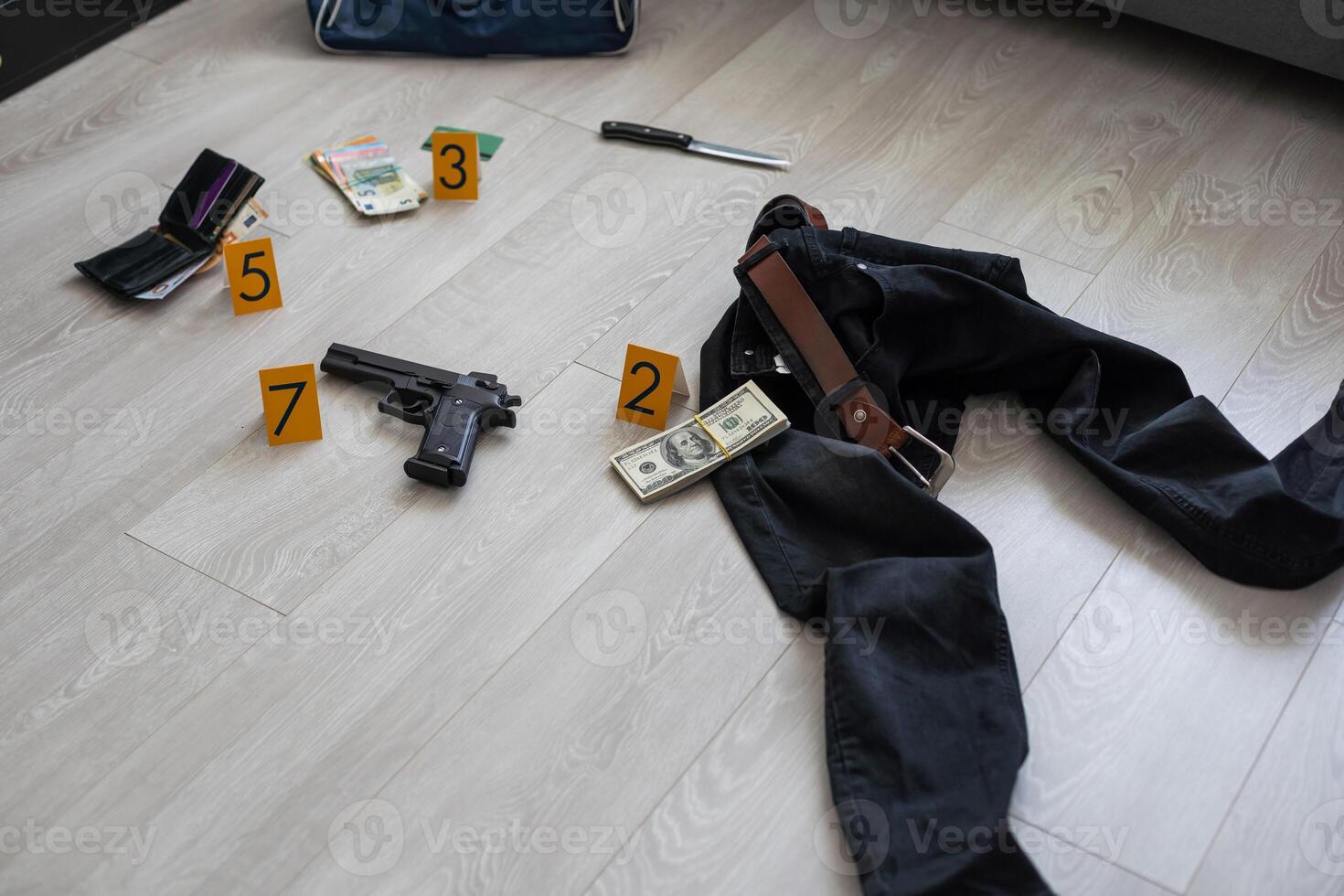 Crime scene investigation concept - Pistol and bullet shell against the yellow crime marker on apartment floor photo