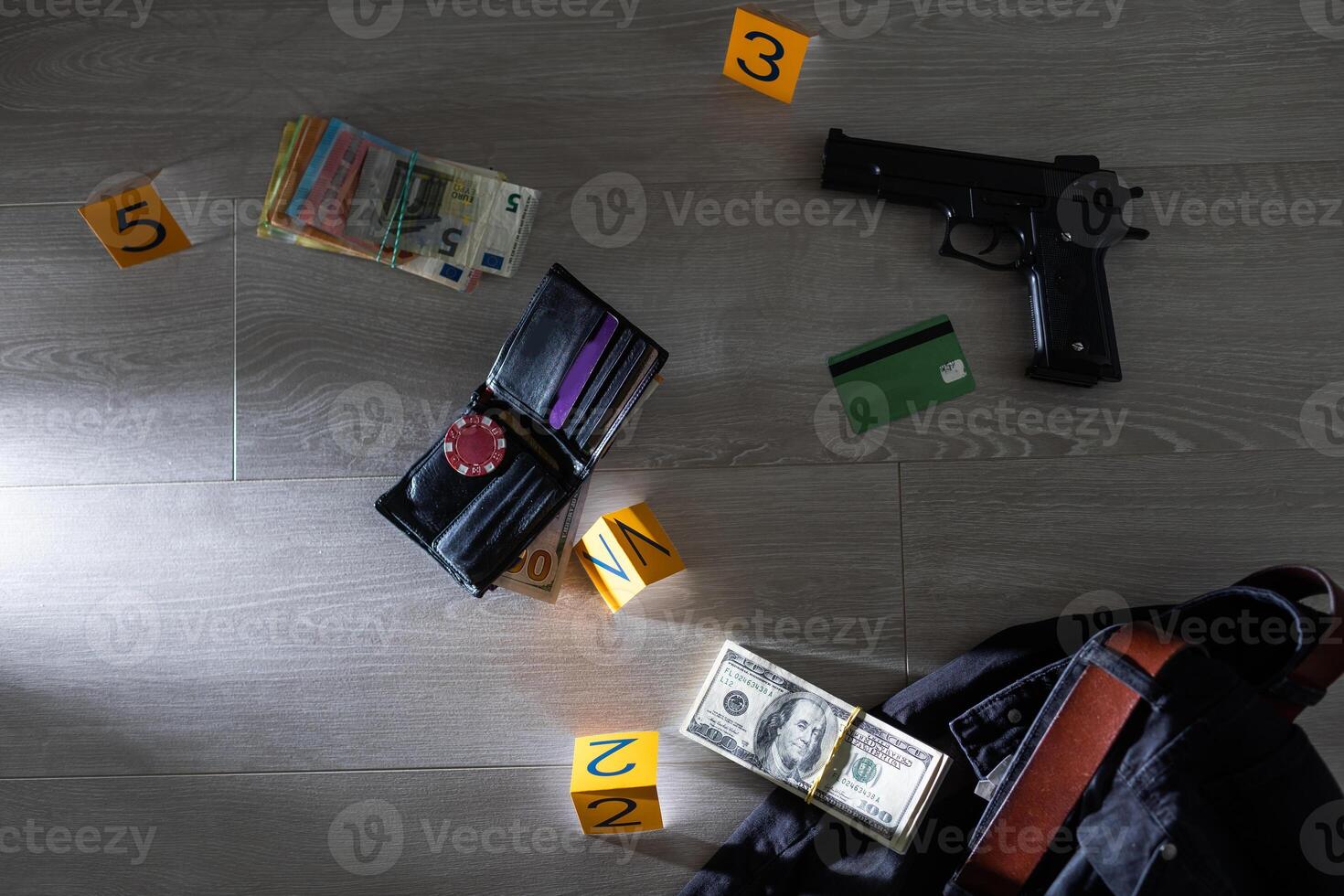 Crime scene investigation - numbering of evidences after the murdering in apartment. Brass knuckle, wallet and clothes with evidence markers photo