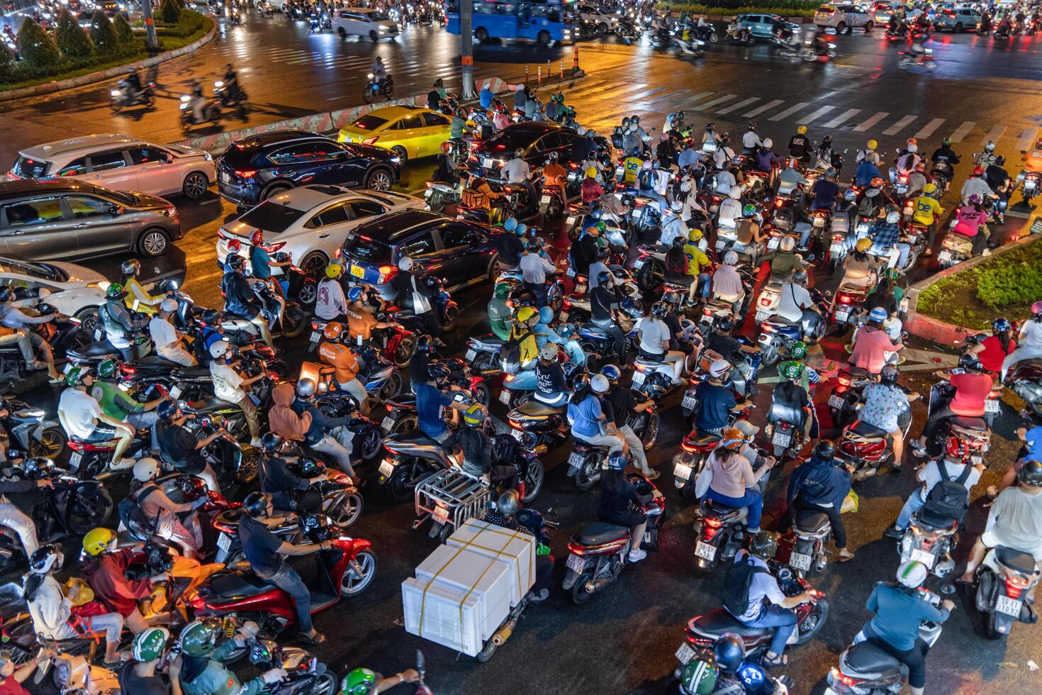 Ho Chi Minh city, Vietnam - 18 Jun 2024 Busy traffic jam during rain and Landmark 81 of Dien Bien Phu St with numerous shop sign boards, crowded with people, motorbikes photo