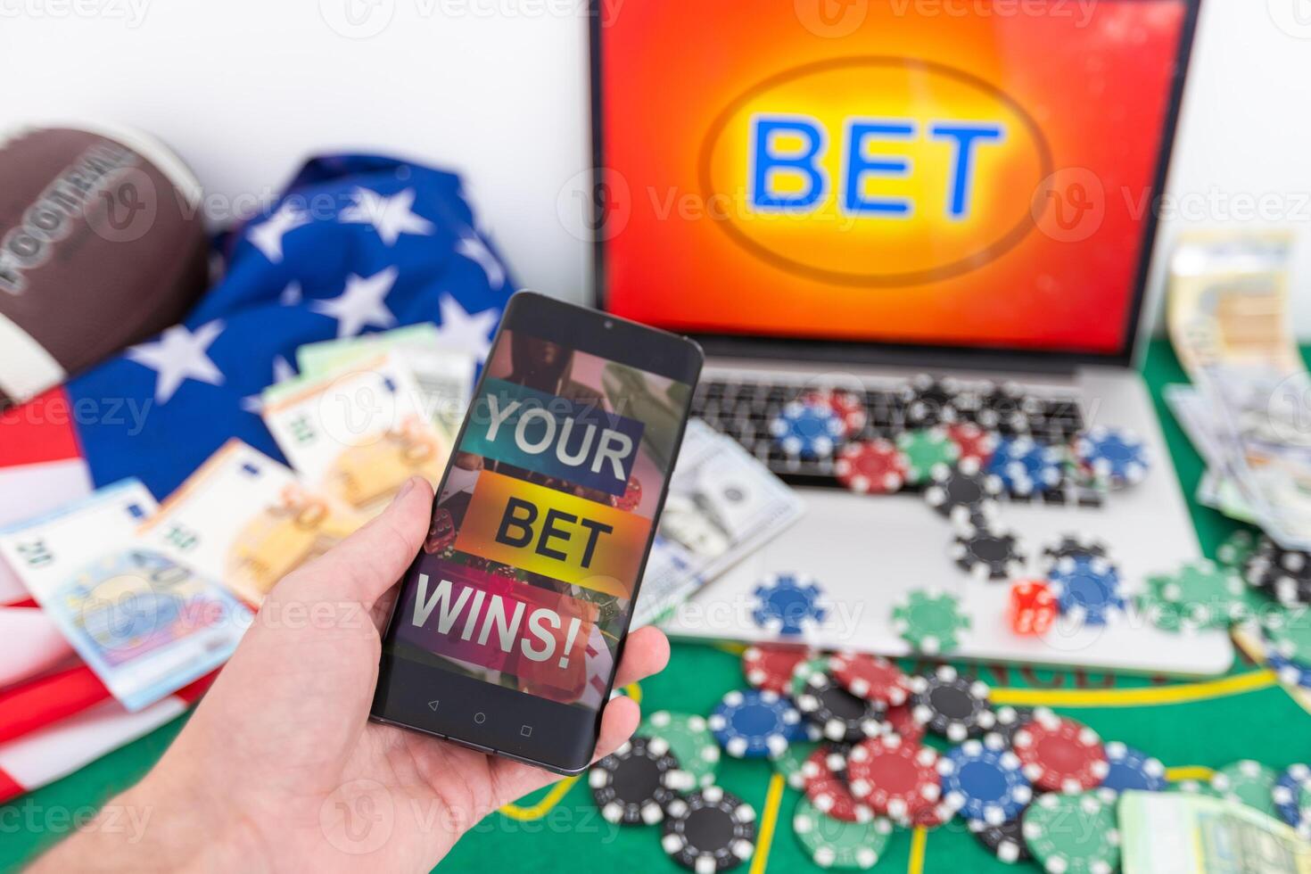 hands of a man holding a online betting device. All screen graphics are made up. photo
