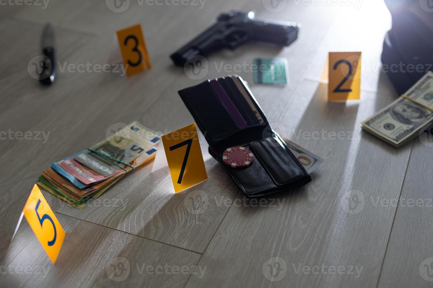 Crime scene investigation - numbering of evidences after the murdering in apartment. Brass knuckle, wallet and clothes with evidence markers photo
