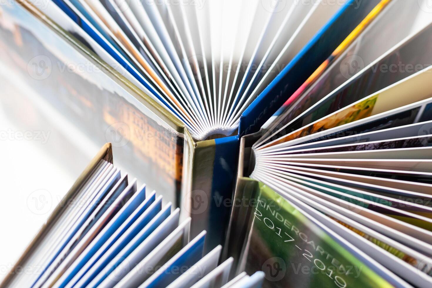 Colored spines of books lying on top of each other. Selective Focus. photo