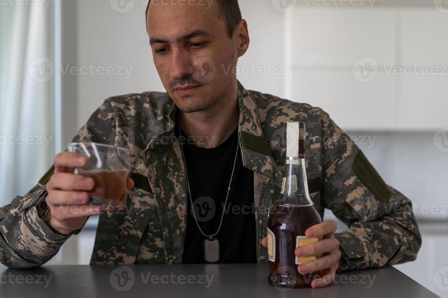 A man with a beard drinks alcohol. photo