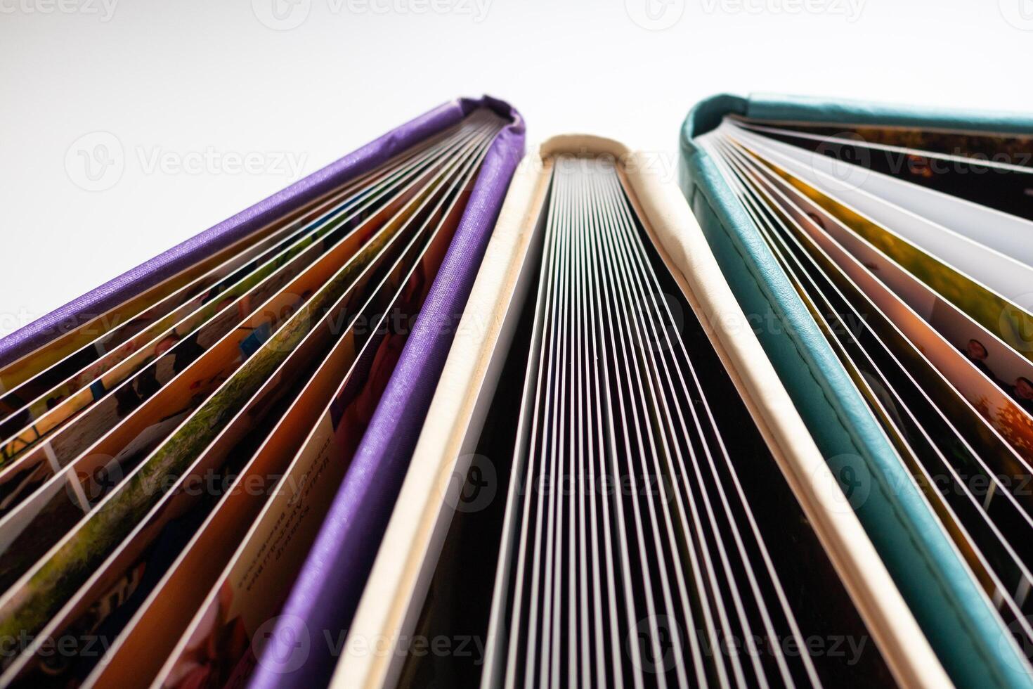 Books. A lot of books with bright covers in one pile isolated on white background. Design element, paper and leather texture. Colorful books on the shelf, close up photo