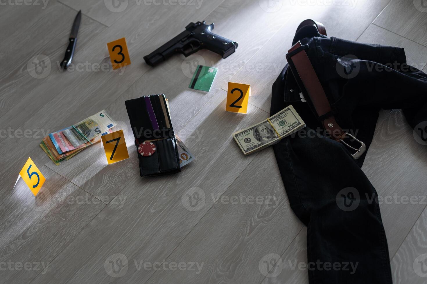 Crime scene investigation concept - Pistol and bullet shell against the yellow crime marker on apartment floor photo