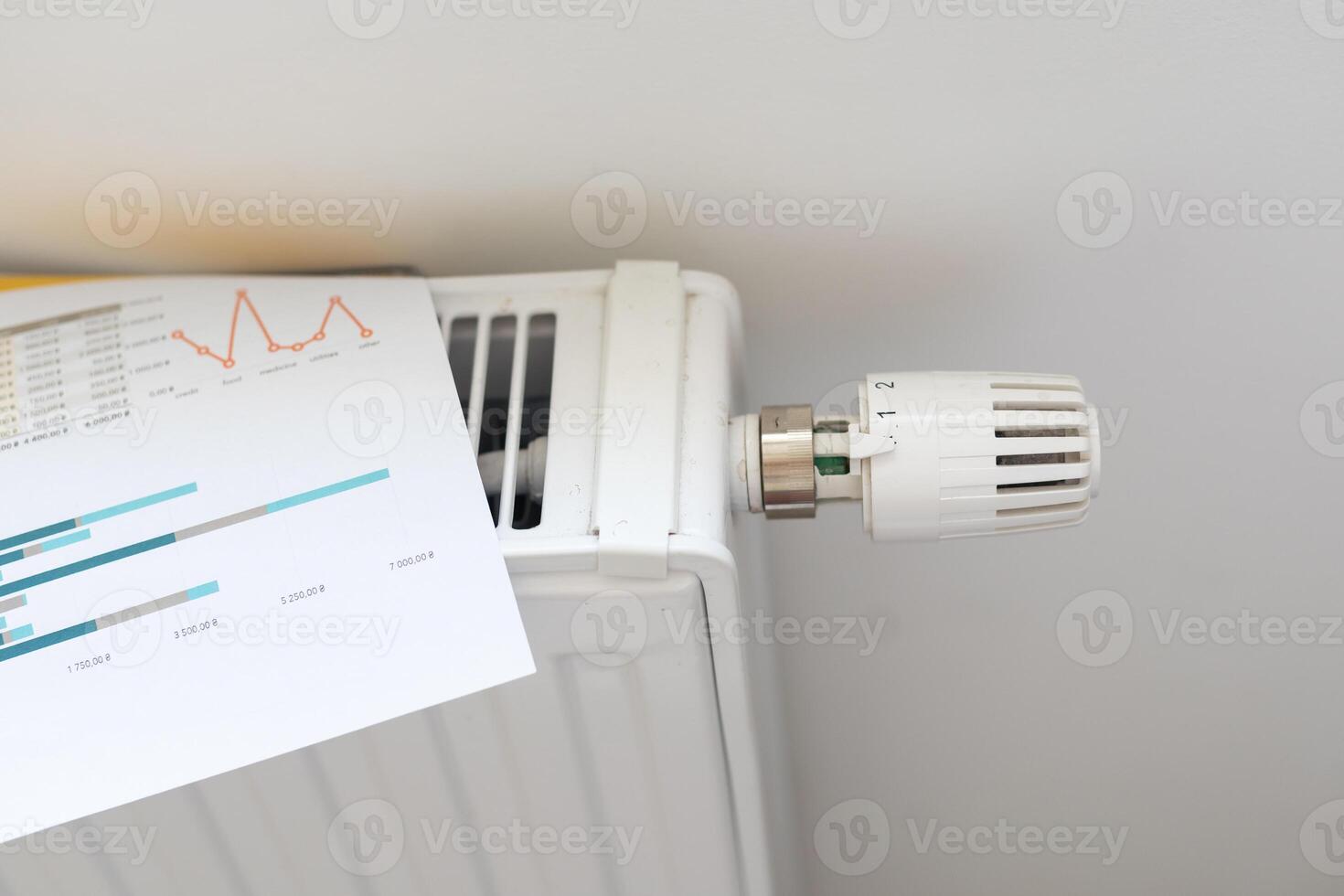 gas bill in front of heating radiator. Payment for heating in winter. photo