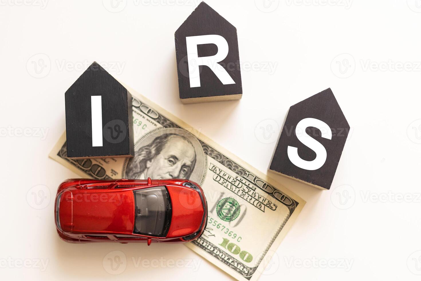 IRS on wooden cubes with calculator and fake money on the table. photo
