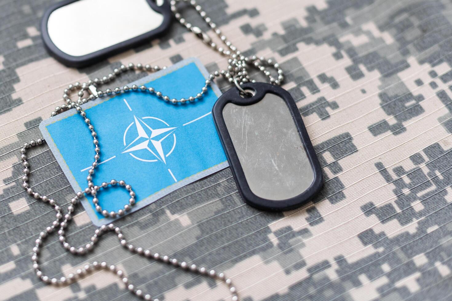 Army tokens on military uniform background photo