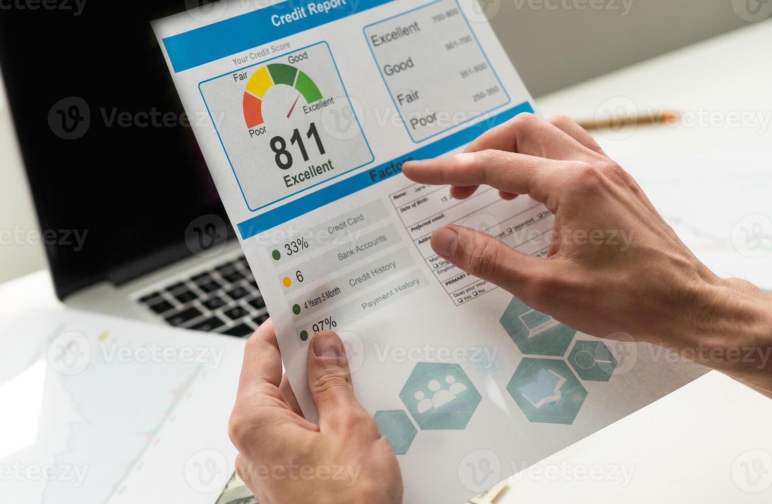 cropped view of man holding paper with credit report letters near laptop with blank screen photo
