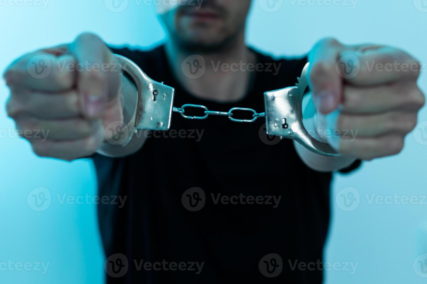 Male hands in handcuffs black background photo