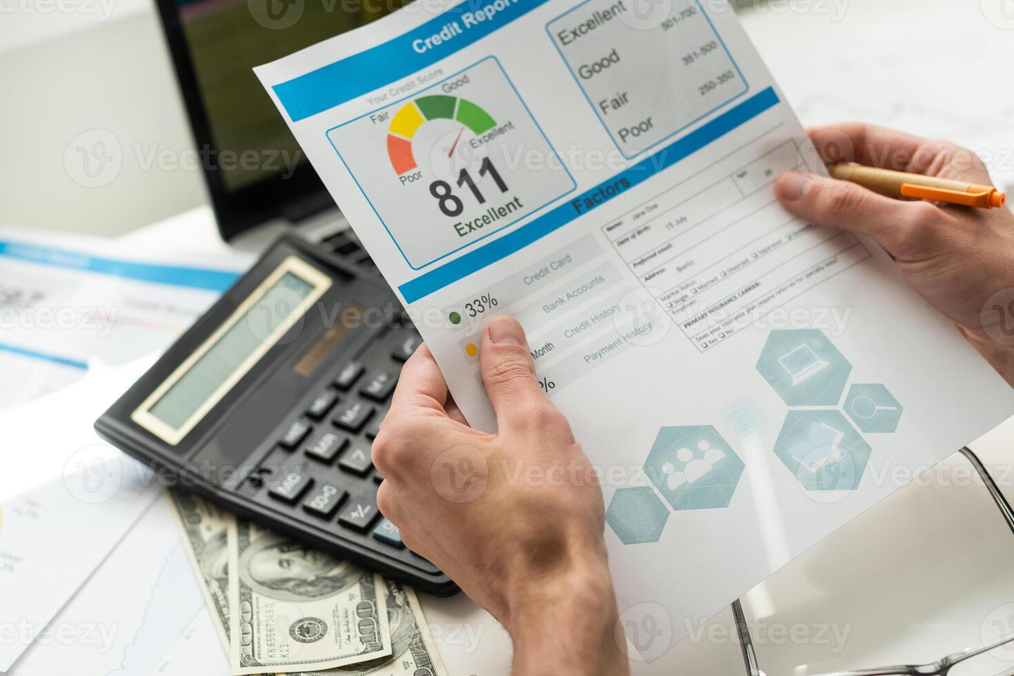 cropped view of man holding paper with credit report letters near laptop with blank screen photo