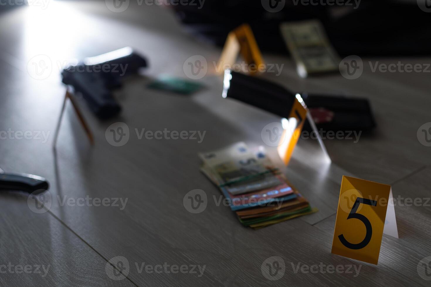 Crime scene investigation concept - Pistol and bullet shell against the yellow crime marker on apartment floor photo