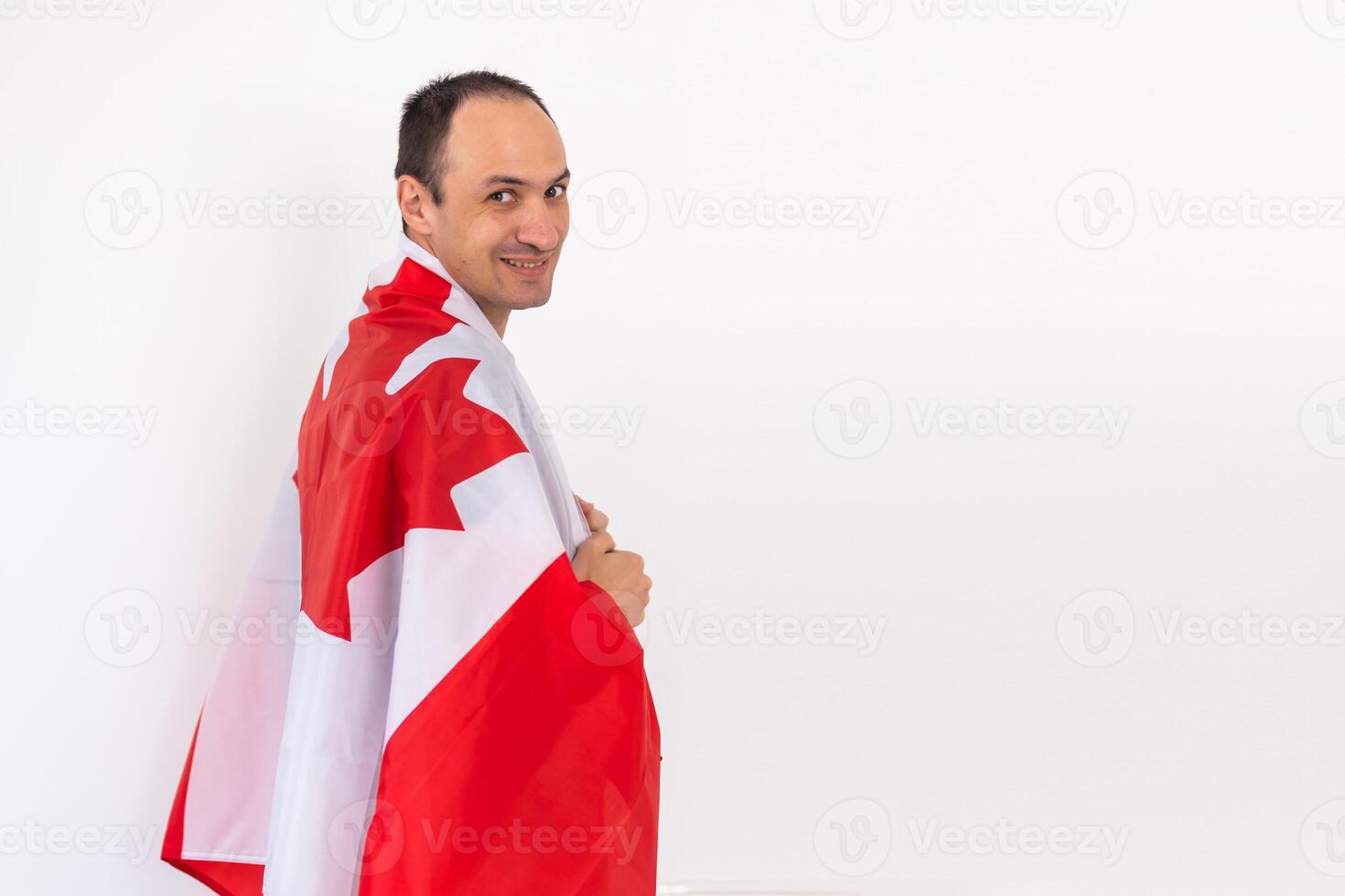 Young man with flag of Canada on white background photo