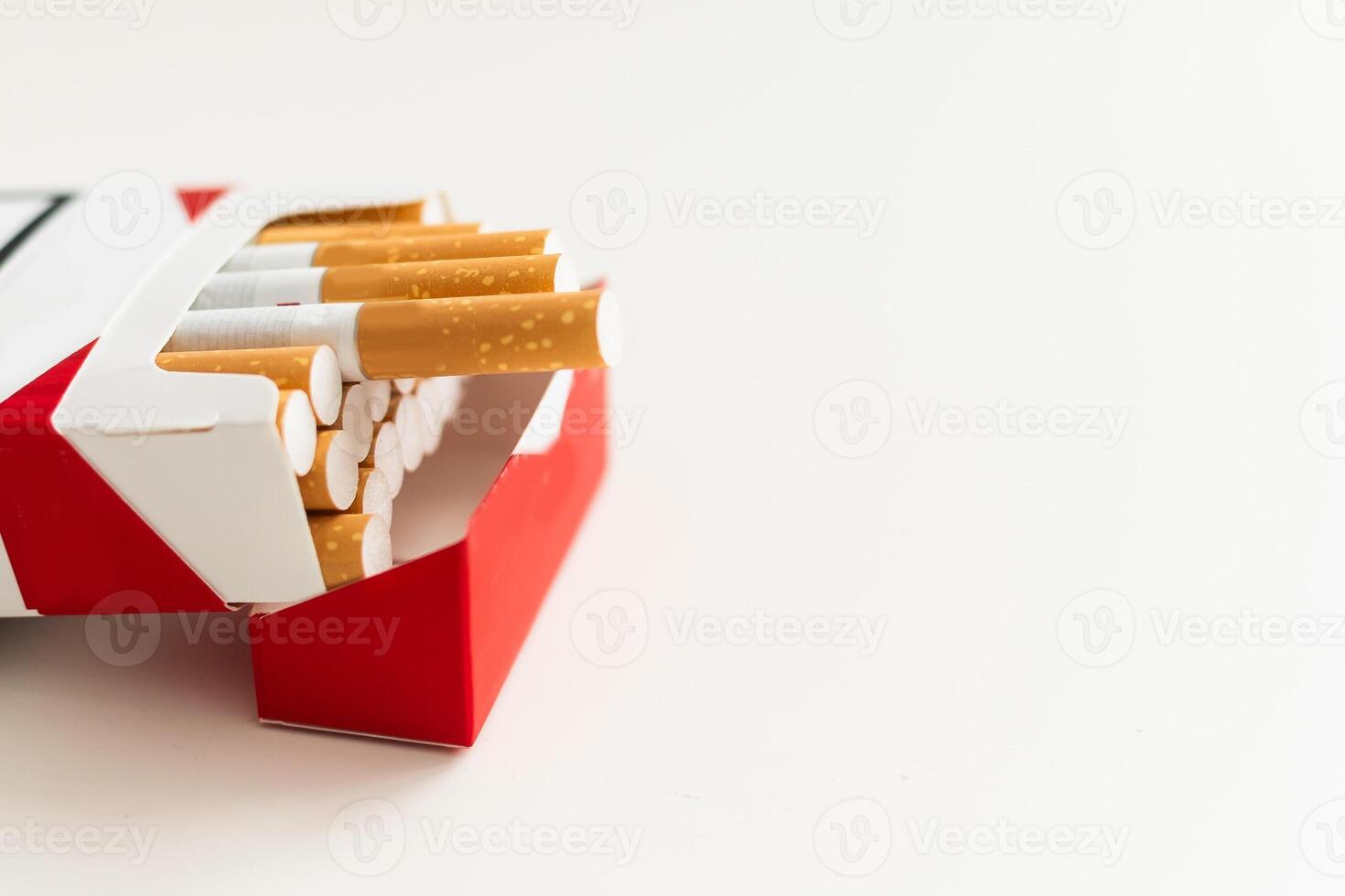 Open pack of cigarettes on a white background photo