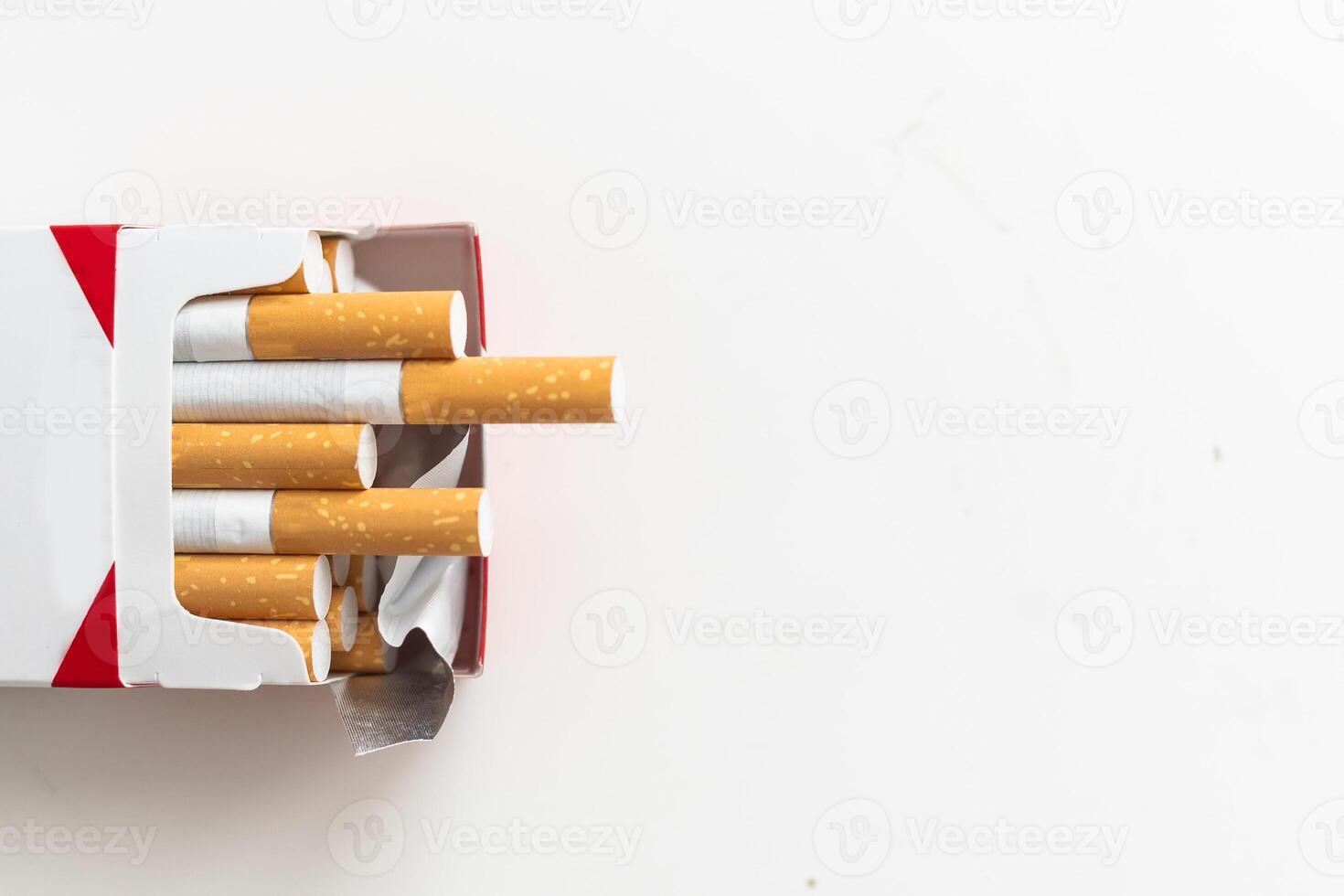 Open blue pack of cigarettes isolated on white background. Box of cigarettes closeup. photo