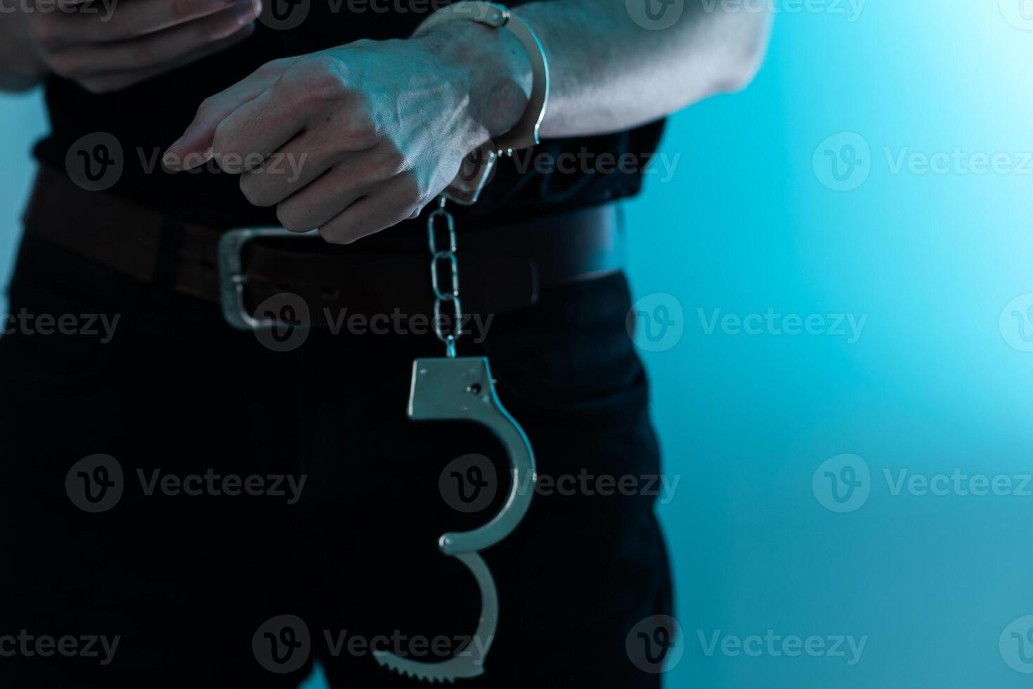 Young man desperate to catch the iron prison,prisoner concept,Handcuffed hands of a prisoner in prison, Male prisoners were severely strained in the dark prison, violence, photo