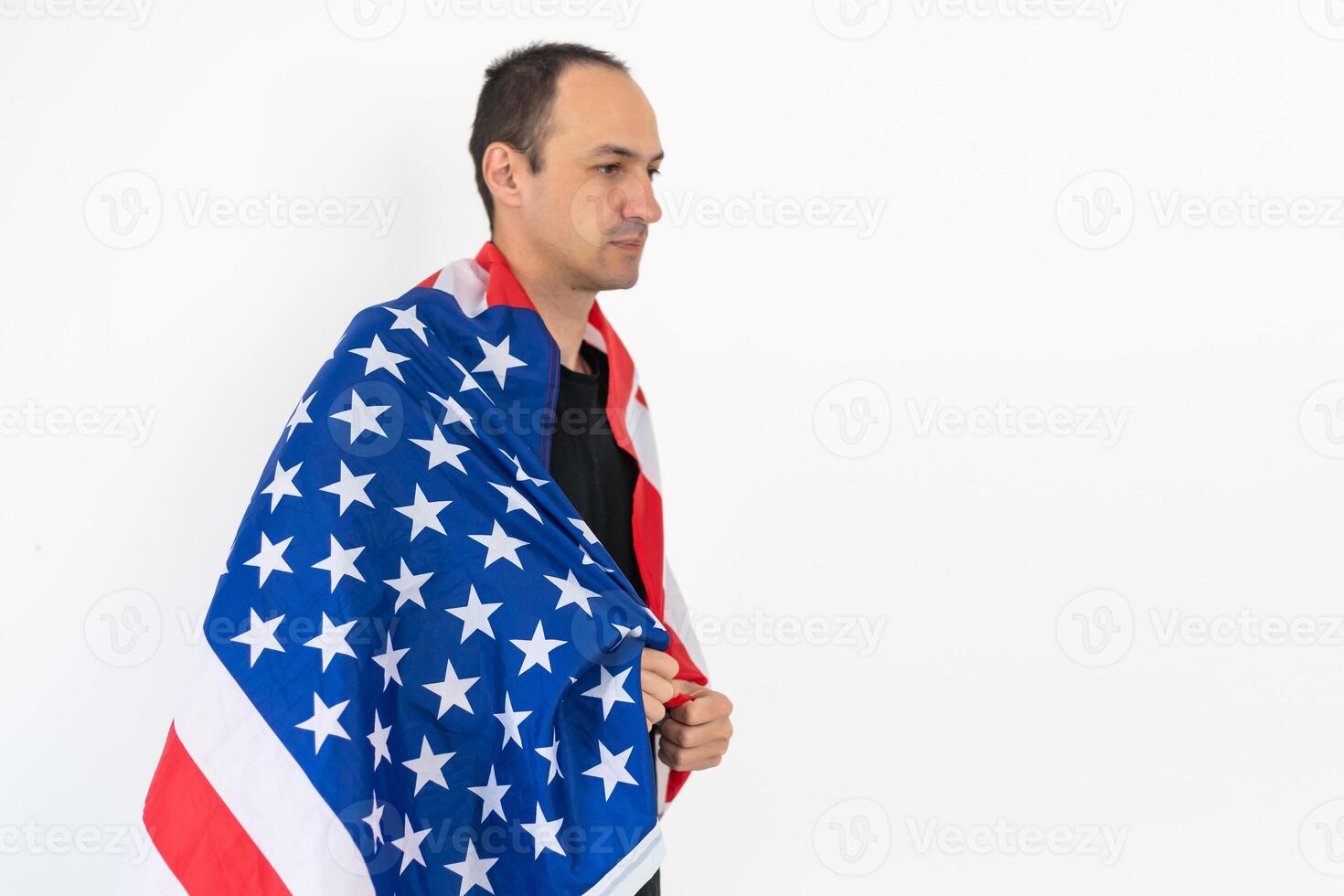 young attractive businessman wrapped in american flag, studio shoot isolated on white background photo