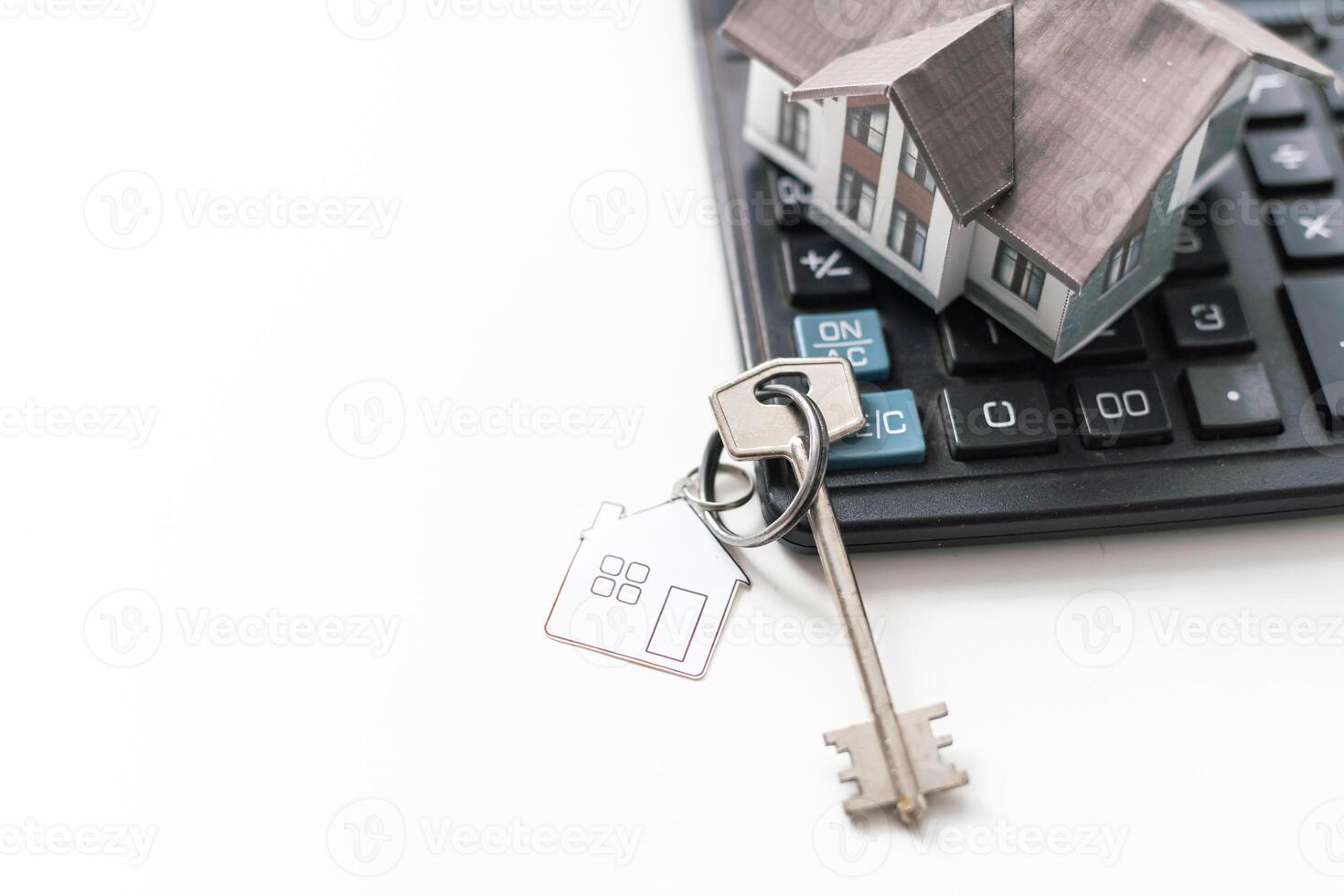 Buying a house, building repair and mortgage concept. Estimation real estate property with loan money and banking. Plan of a house, keys and calculator on white background. photo