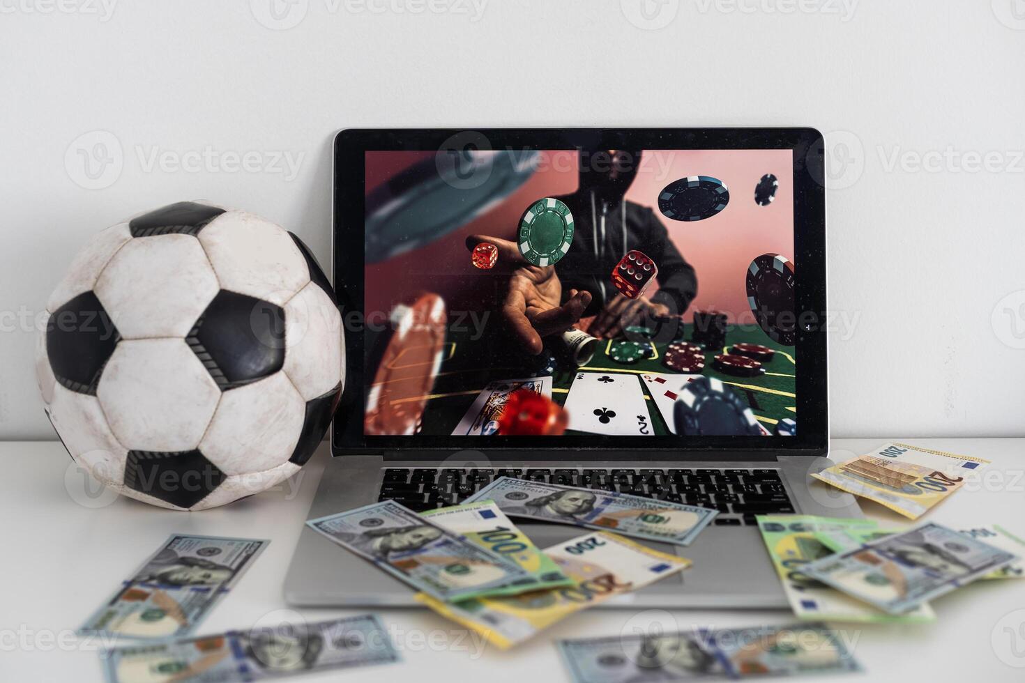 Front view cropped shot of male hands clenching fists with triumph. Man using his laptop and smartphone for making bets online at bookmaker's website and mobile application. photo
