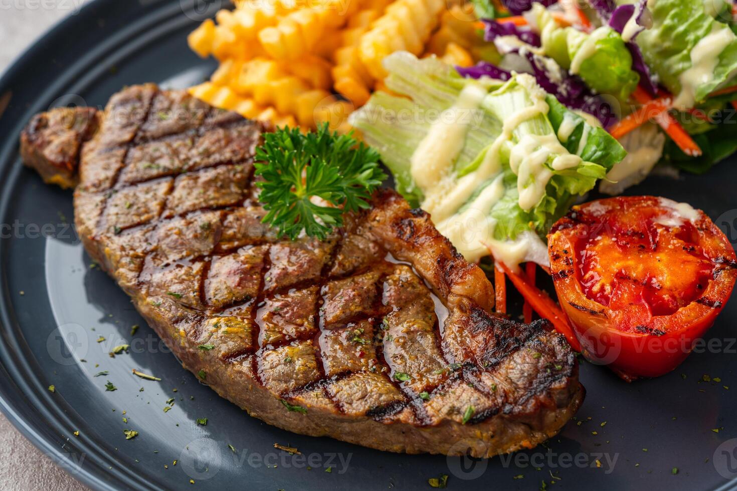 Grilled Sirloin Beef Steak with french fries and salads. photo