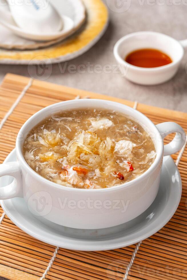 Shark fin soup or Soup Sirip Ikan Hiu is a popular soup in Chinese cuisine which is usually served on special occasions such as weddings or banquets. photo
