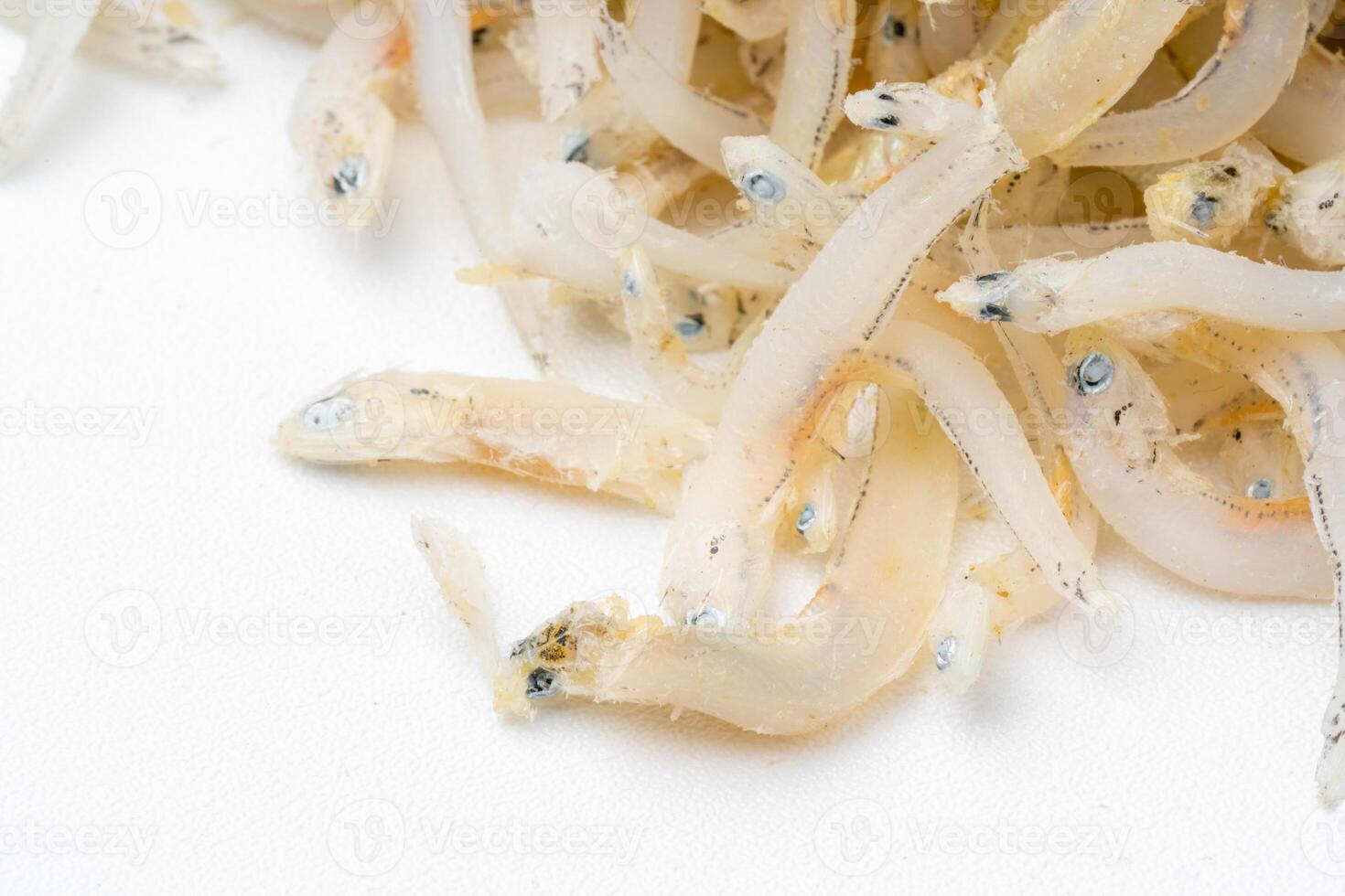 Fresh dried anchovies on White Background. Raw dry salted sea fish. saltwaterforage fish. Ikan asin teri medan. photo