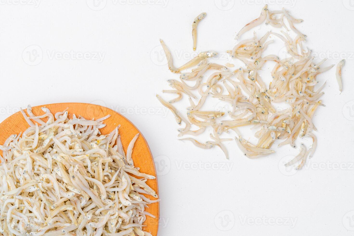 Fresh dried anchovies on White Background. Raw dry salted sea fish. saltwaterforage fish. Ikan asin teri medan. photo