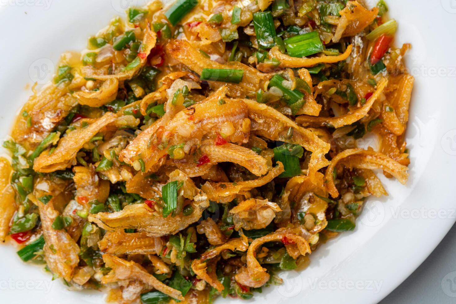 Fried anchovy cooked with green chili or ikan teri cabe ijo is a traditional food from west sumatra, Indonesia. photo