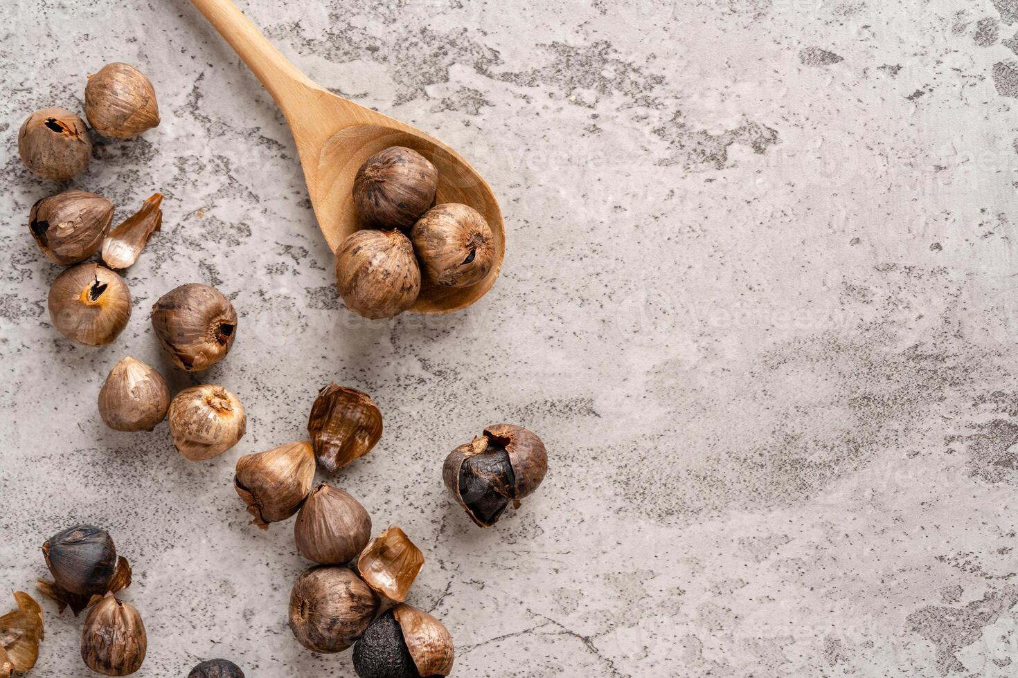 Fermented black garlic. The color is a result of the Maillard reaction or caramelization. Black garlic can help to regulate blood sugar levels photo