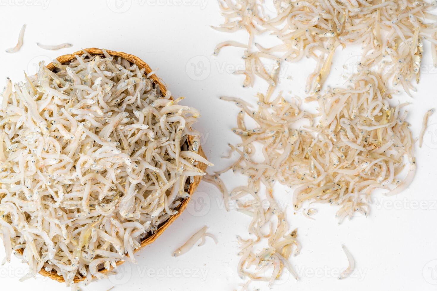 Fresh dried anchovies on White Background. Raw dry salted sea fish. saltwaterforage fish. Ikan asin teri medan. photo