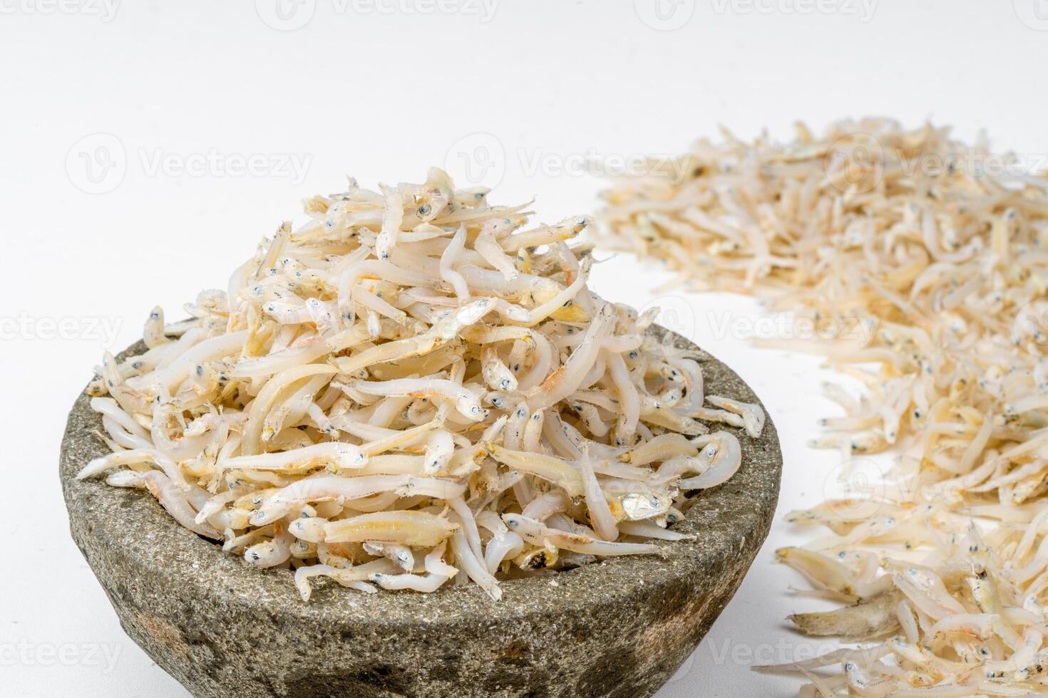 Fresh dried anchovies on White Background. Raw dry salted sea fish. saltwaterforage fish. Ikan asin teri medan. photo
