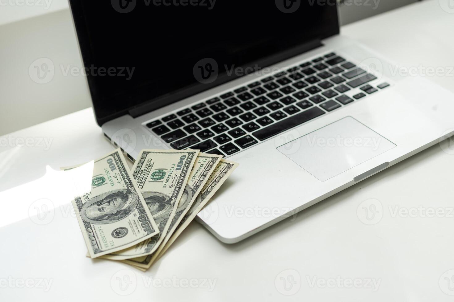 Silhouette of cropped shot of a young man working from home using smart phone and notebook computer, man's hands using smart phone in interior, man at his workplace using technology, flare light photo