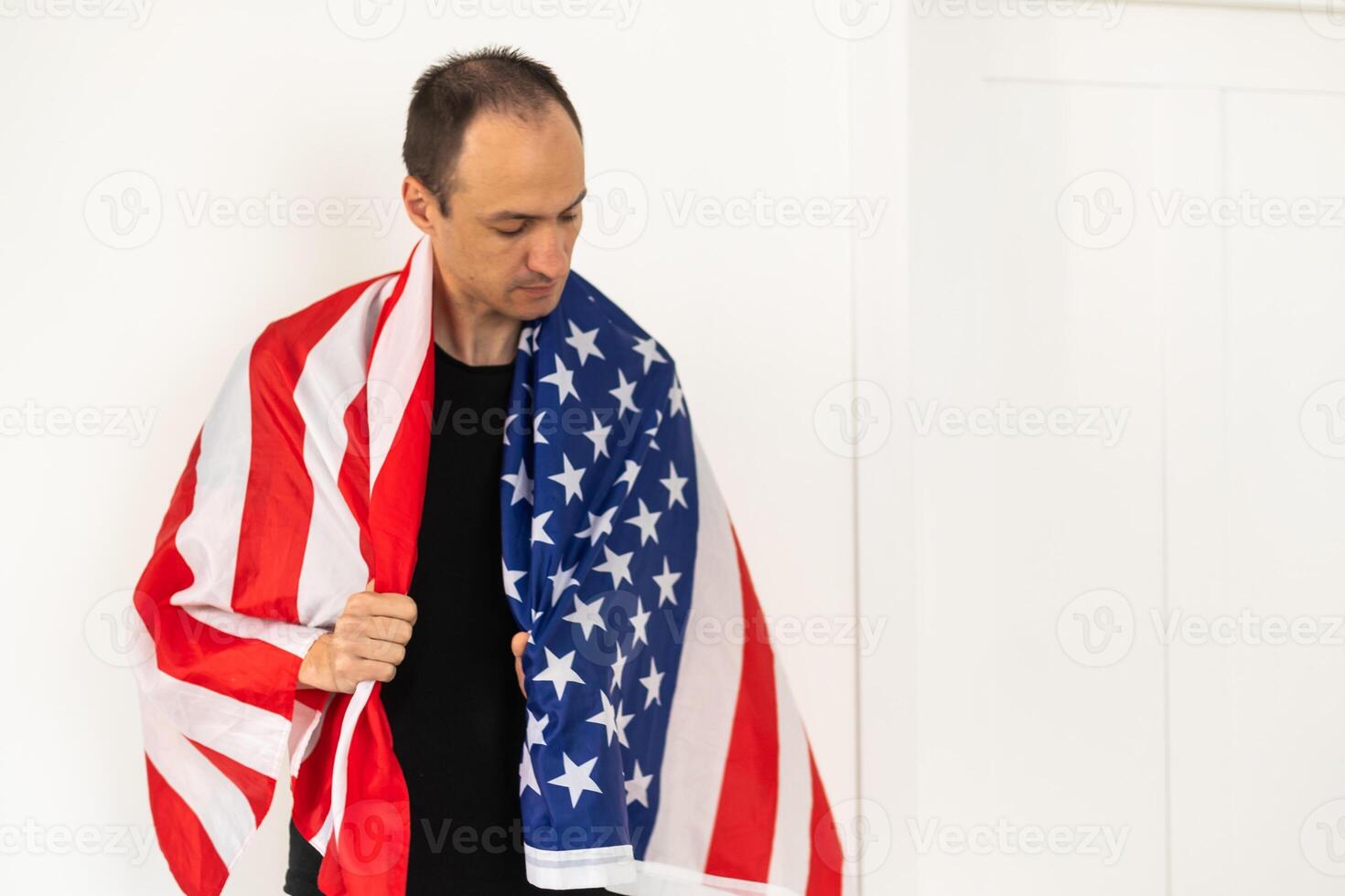 Man standing and putting country flag around the shoulder photo