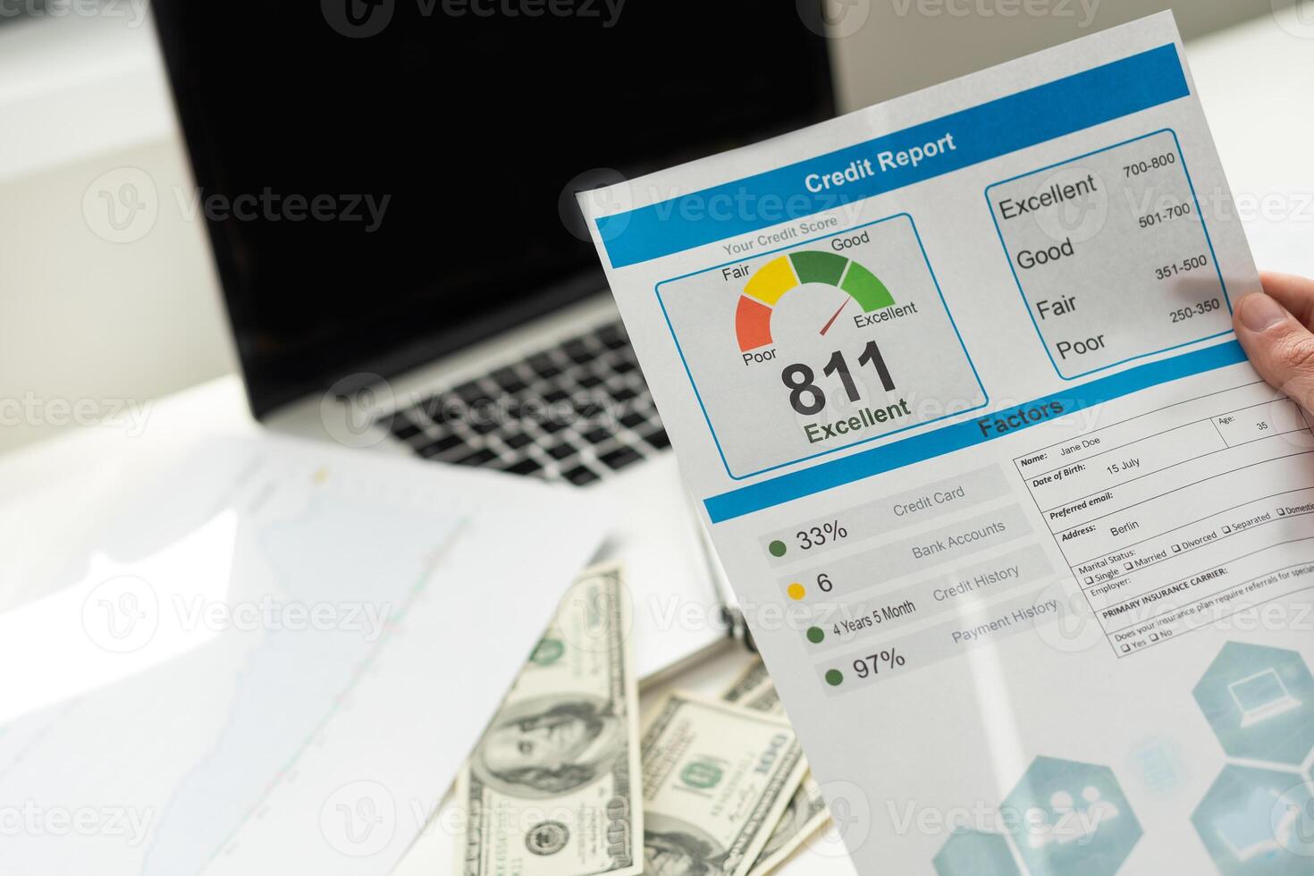cropped view of man holding paper with credit report letters near laptop with blank screen photo