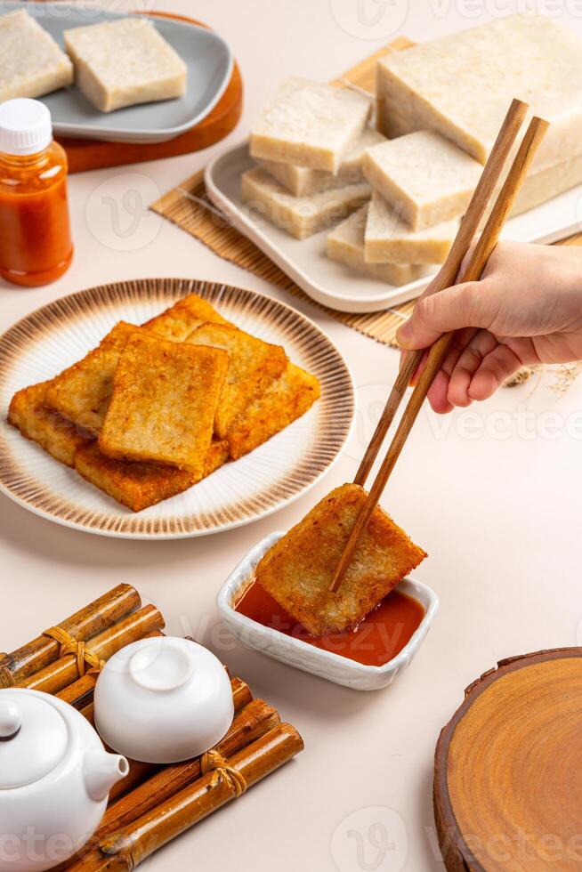 Turnip cake or Chai tow kway. Turnip cake is a common dish or dim sum of Teochew cuisine in Chaoshan, China usually cut into rectangular slices and sometimes pan fried before serving photo