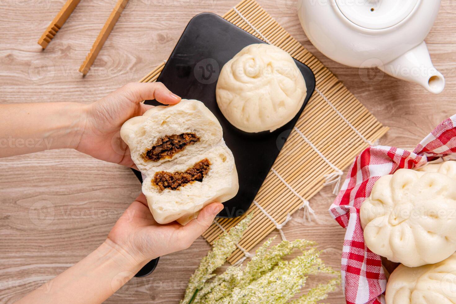Baozi or Bakpao is a type of yeast-leavened filled bun in various Chinese cuisines. photo