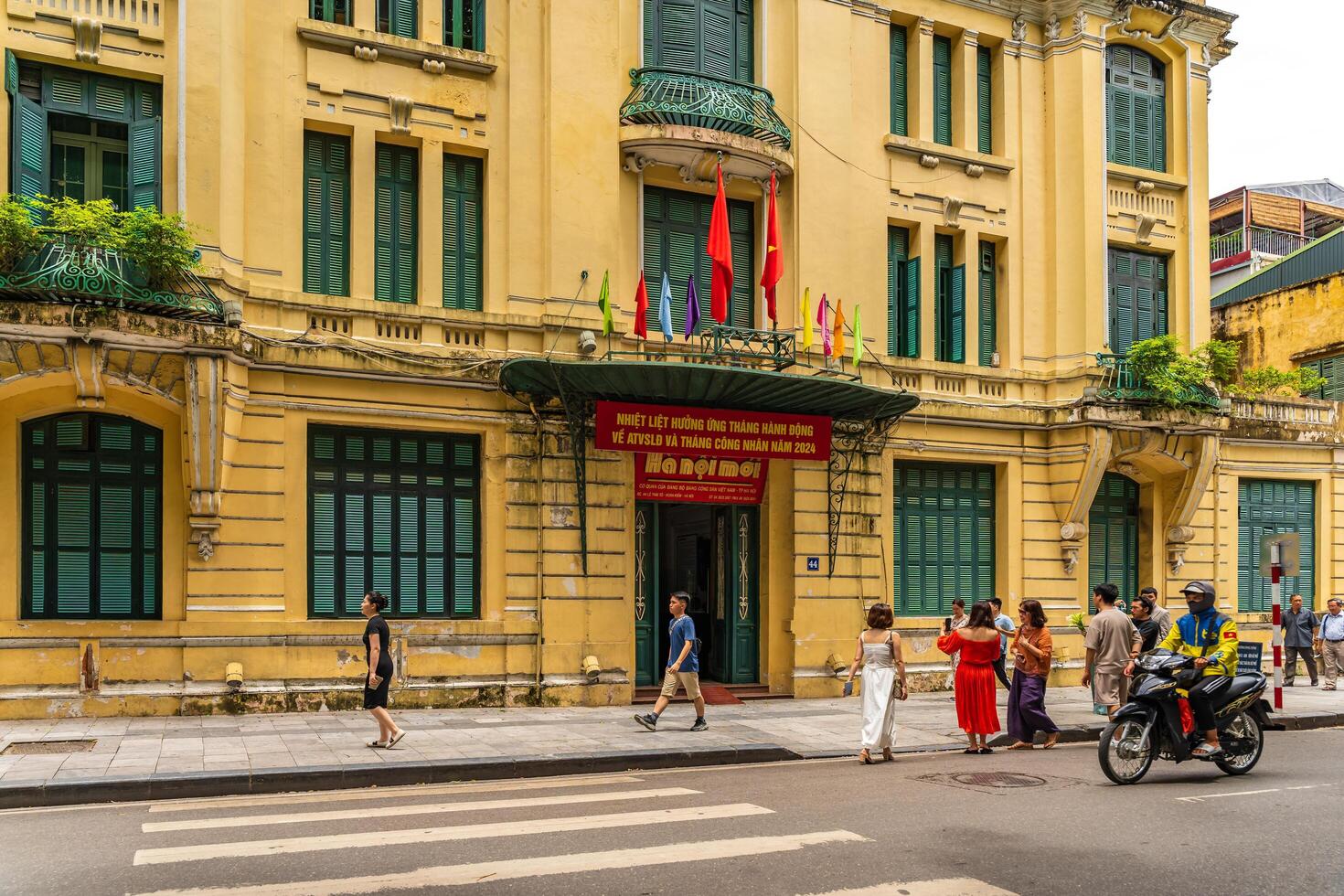 Hanoi, Vietnam - 26 June 2024 Hanoimoi newspaper check-in point near by Hoan Kiem lake. People have exercise in the morning on Ho Guom lake photo