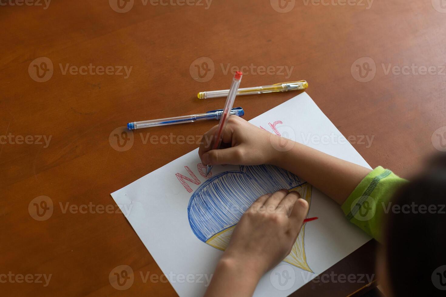 Ukrainian flag and a heart in yellow and blue color. Child draws a heart on the blackboard photo