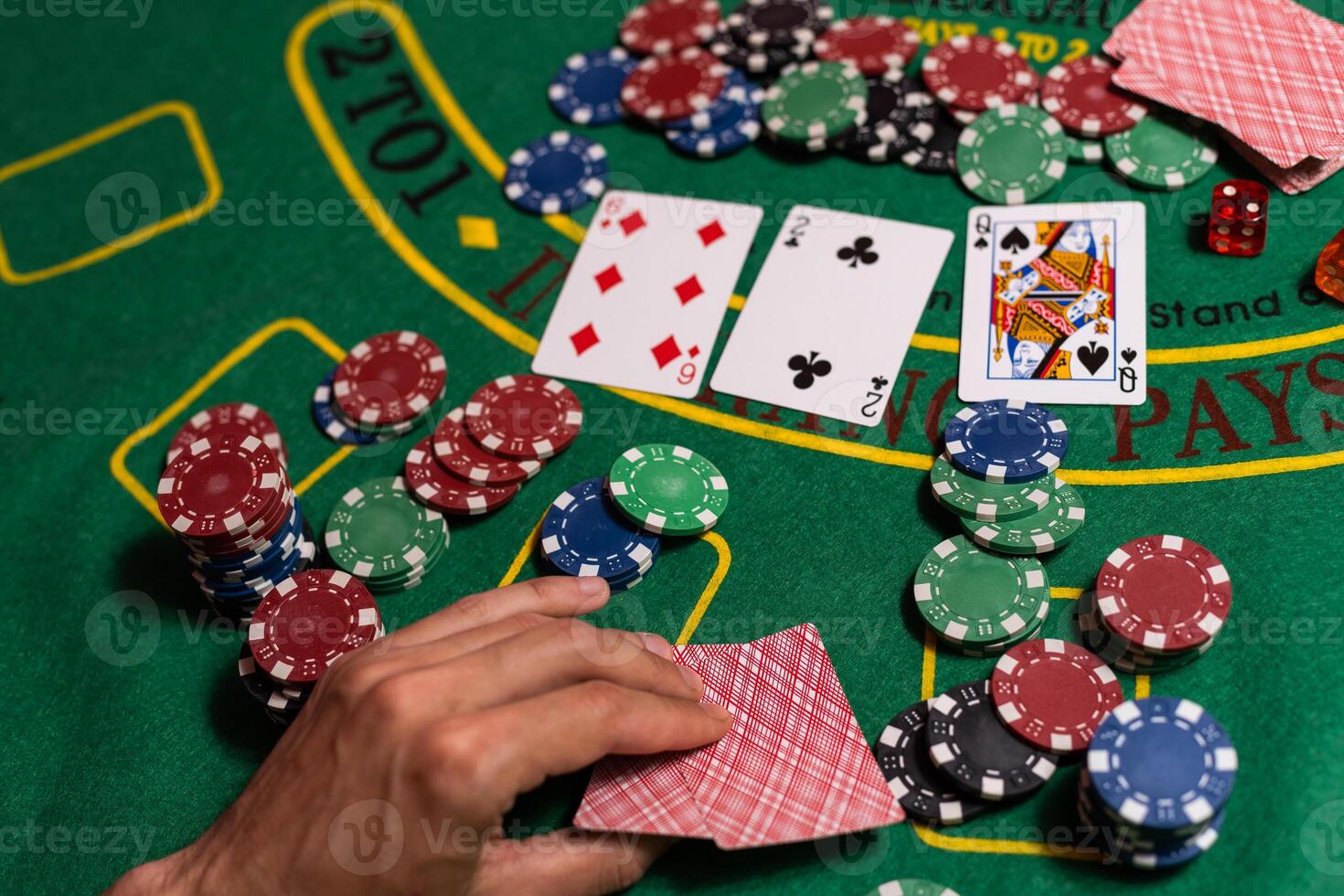 Happy poker player winning and holding cards. photo
