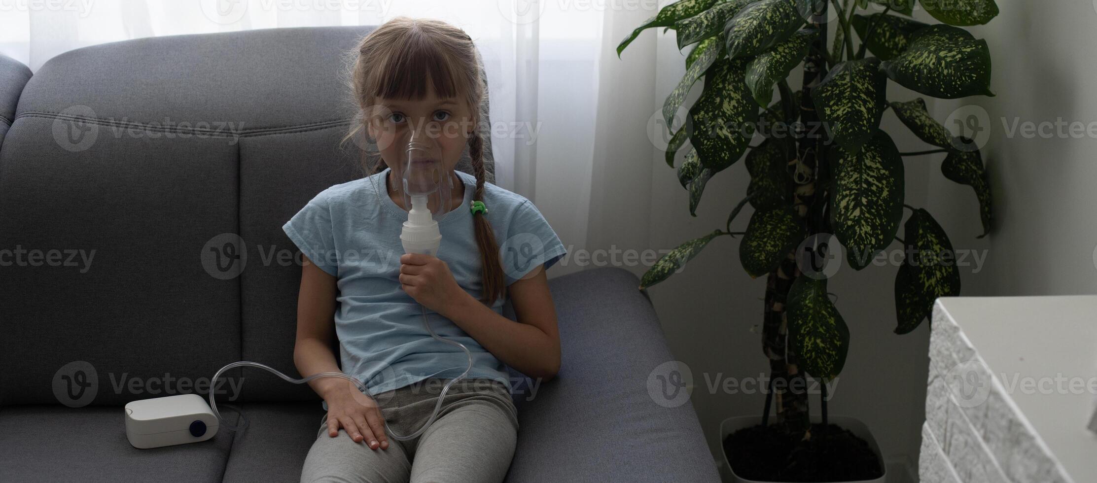 Little girl making inhalation with nebulizer at home. child asthma inhaler inhalation nebulizer steam sick cough concept. photo