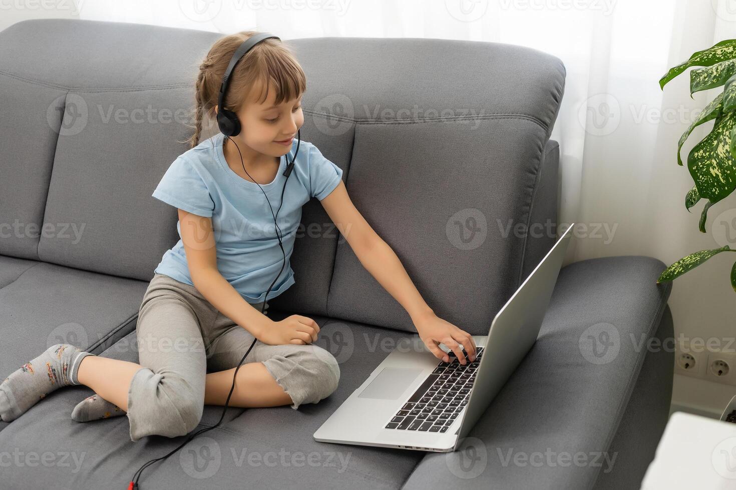 Back view of young girl sit at home, talk have online call lesson with teacher or tutor, teenage schoolgirl engaged in webcam conversation, study distant use web conference app on laptop photo