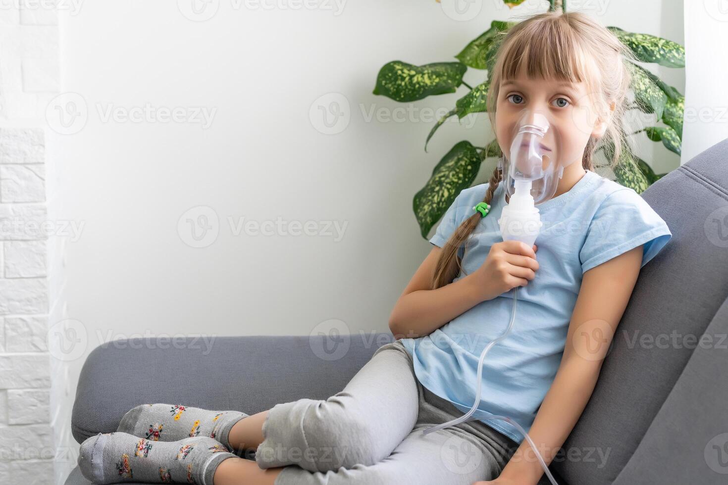 Little girl making inhalation with nebulizer at home. child asthma inhaler inhalation nebulizer steam sick cough concept. photo