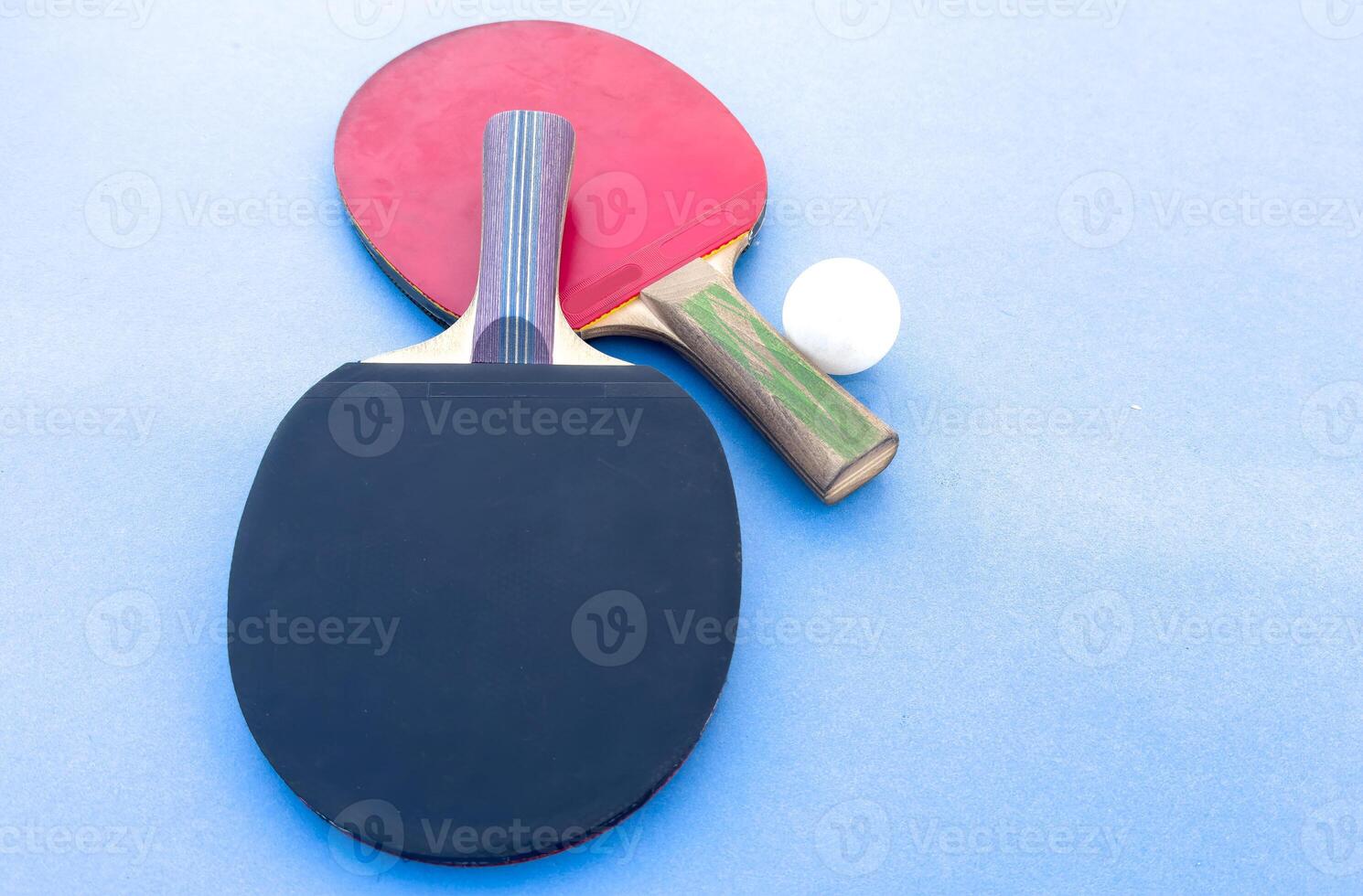 Ping pong table, rackets and balls in a sport hall photo